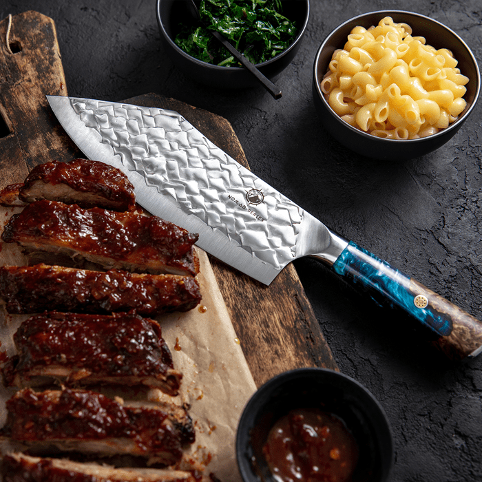 https://www.thecookingguild.com/cdn/shop/products/NomadCleaver2.png?v=1698315642&width=1445